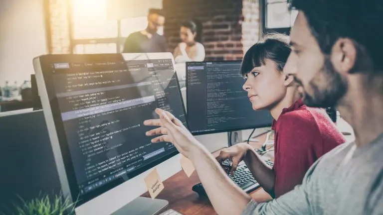 programmers reviewing code on computers