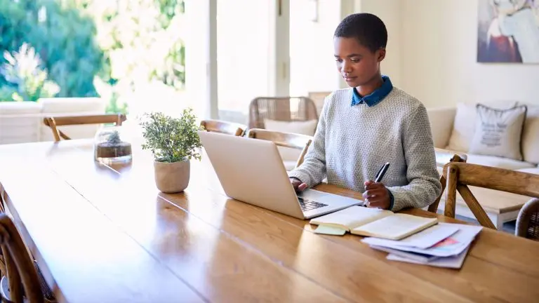 boy studying on laptop indoors