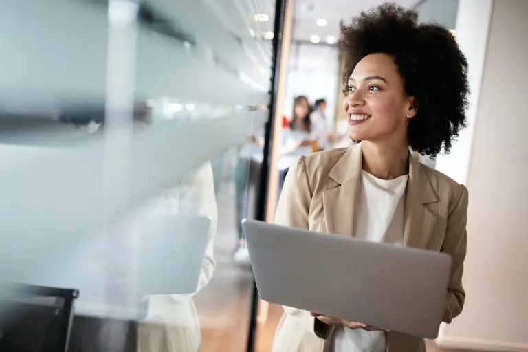 woman with laptop smiling